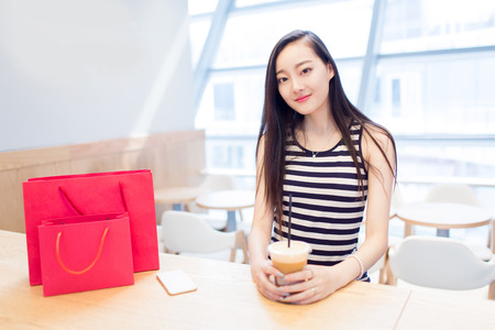 chinese girl in the mall sitting in the cafeの写真素材