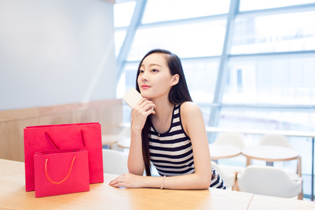chinese girl in the mall sittingの写真素材