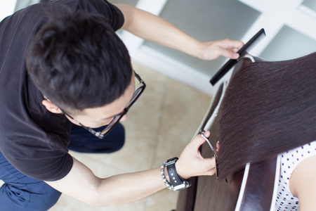 china professional hair stylist, at a pretty girl trim long hairの写真素材