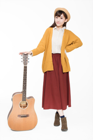 beautiful beautiful musician, holding a guitar, playing wonderful musicの写真素材