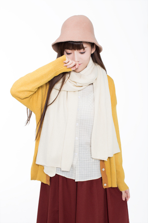 lovely beautiful chinese girl, standing in the studio in white, do the movements showの写真素材