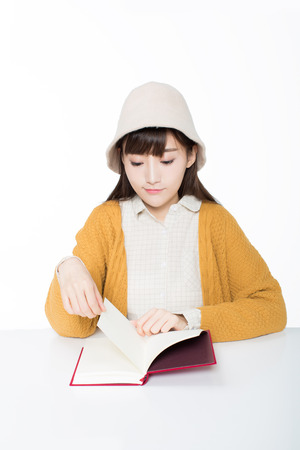 cute chinese female students in the classroom holding books read.の写真素材