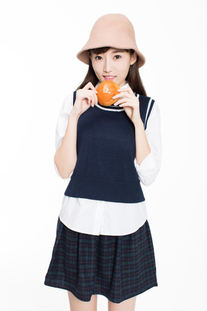 pretty c hinese girl, she holding fruit in the room. In the white backgroundの写真素材