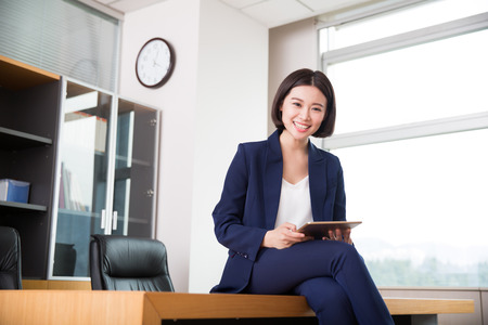 young beautiful girl, sitting in the office began her workの写真素材