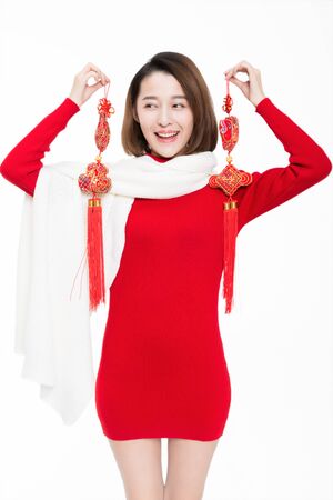 Pretty girl holding Chinese new year decoration, studio shot.の写真素材