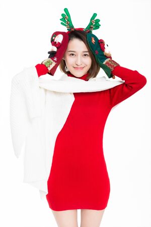 Young woman wearing reindeer antler with christmas socks, studio shot.の写真素材