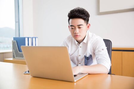 fashion handsome boy, wearing a white shirt, is the company's staffの写真素材