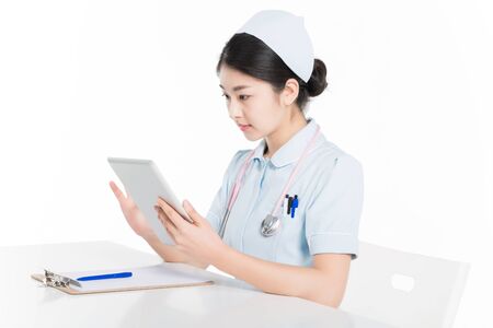 Female nurse using digital tabletの写真素材