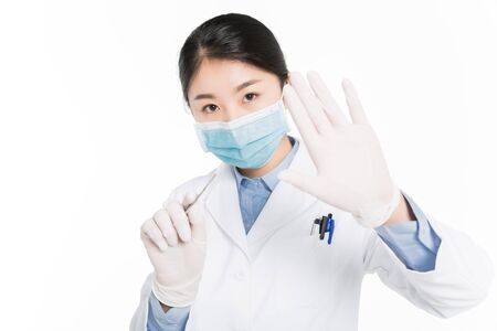 Young woman with surgical equipment showing hand gestureの写真素材