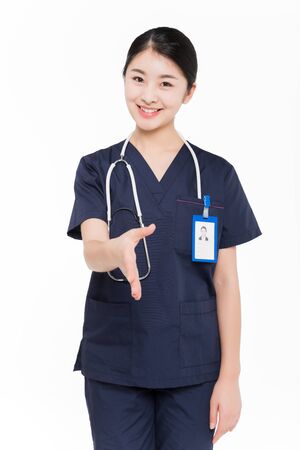 Female surgeon extending arm for handshakeの写真素材
