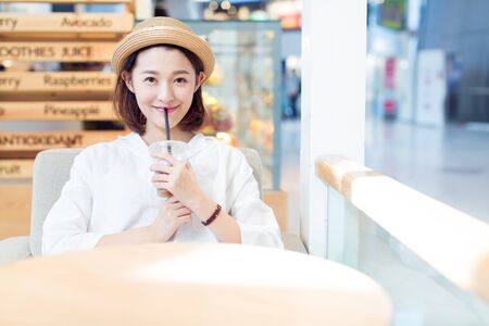 beautiful woman enjoying leisure time in a shopping center,shandong province,china.の写真素材