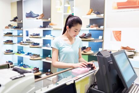 beautiful chinese girl in the mall to choose their own clothingの写真素材