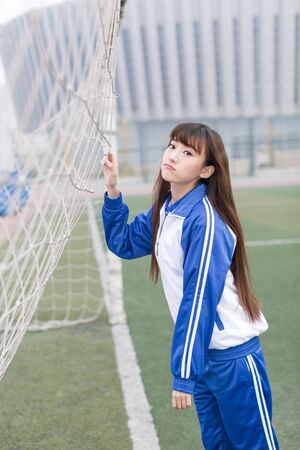 cute chinese female high school students on the campus playgroundの写真素材