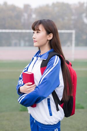 cute chinese female high school students at the campus playgroundの写真素材