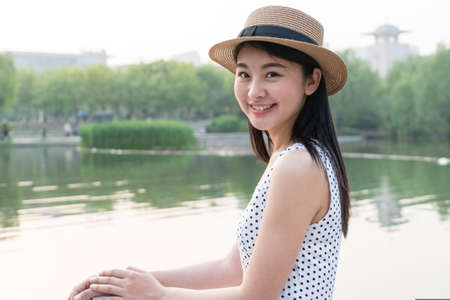 asina woman enjoying the lake view, in springの写真素材