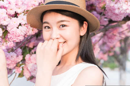 asina woman enjoying the lake view, in springの写真素材