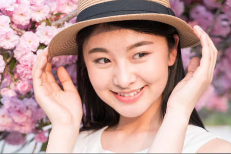asina woman enjoying the lake view, in springの写真素材