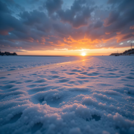 Beautiful winter sunset over frozen lake with snowdrifts. Landscape.の素材
