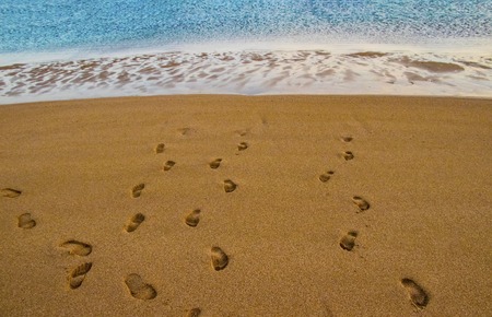 Beach sand footprint ocean coast sea azure wave with bubble. Tropical travel, summer vacation holiday paradise resort background template. Human steps on shoreの写真素材