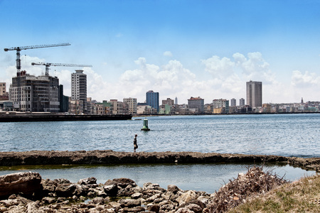 View of the panoramatic Havana in Cuba. There is blue sky and blue ocean and a lot of urbanic buildings. It is situated in carribean in America.の写真素材