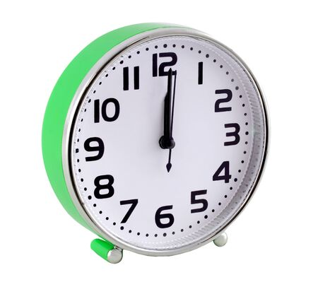 Green alarm clock isolated on white background. The hands are at twelve oclock.