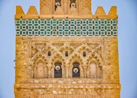 Detail of Islamic Mosque. It is an old architectural building in the middle of the Moroccan city. It is a typical Moroccan building with red bricks. It's a beautiful pattern.の写真素材