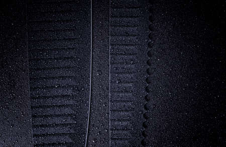 Chefs kitchen black knife blade close up on a black background. Water droplets on the knives.