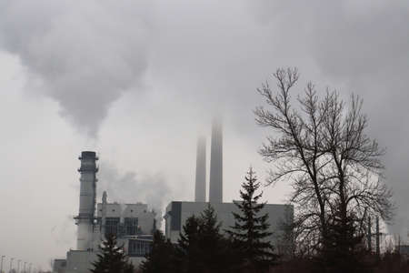 smoggy smoky power generating station on cold winter dayの写真素材
