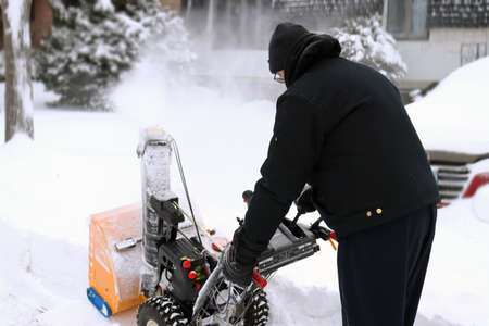 Man snow blowing after winter stormの写真素材