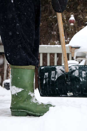 Man shoveling snow after winter stormの写真素材