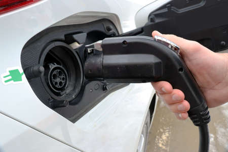 Electric vehicle, EV, being charged up with electricityの写真素材