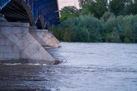 A wild river flowing under the bridgeの写真素材