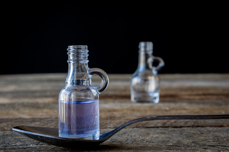 oil bottle with fruits and vegetables on old tableの写真素材