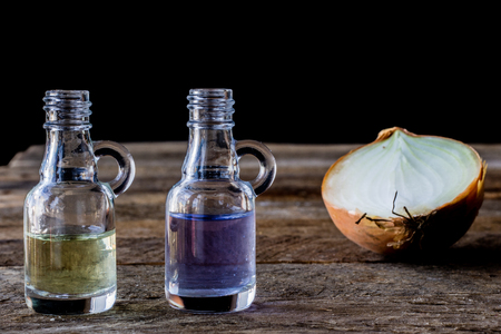 oil bottle with fruits and vegetables on old tableの写真素材