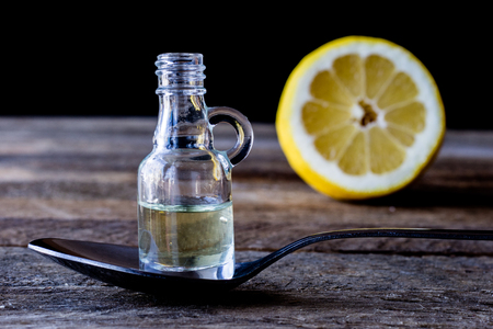 oil bottle with fruits and vegetables on old tableの写真素材
