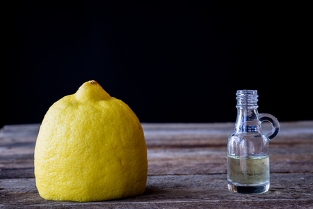 oil bottle with fruits and vegetables on old tableの写真素材