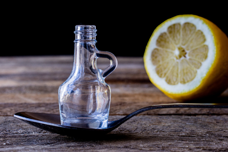 oil bottle with fruits and vegetables on old tableの写真素材