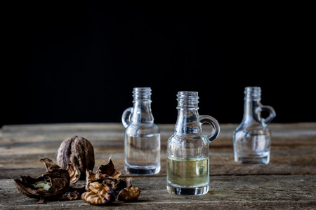 oil bottle with fruits and vegetables on old tableの写真素材