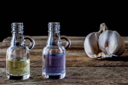 oil bottle with fruits and vegetables on old tableの写真素材
