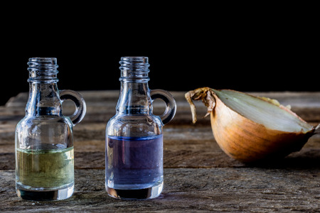 oil bottle with fruits and vegetables on old tableの写真素材