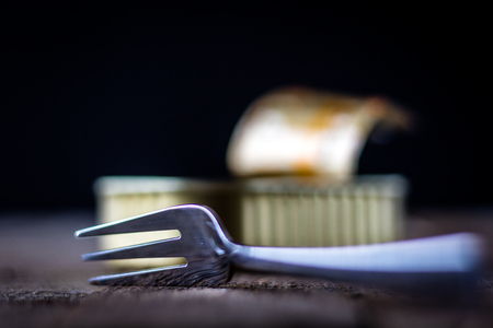 Can and fork on the table in the old kitchenの写真素材