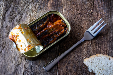 Can and fork on the table in the old kitchenの写真素材