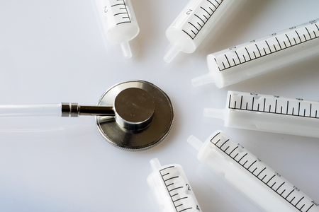 syringes and stethoscope on a withe backgroundの写真素材