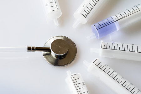 syringes and stethoscope on a withe backgroundの写真素材