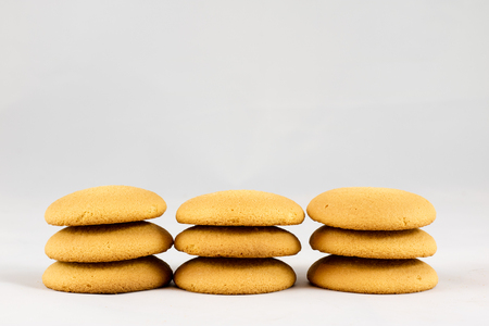 Dry biscuit cakes on white isolated background with jute napkinの写真素材