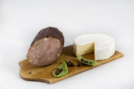 Fresh sausages on a chopping board, white isolated backgroundの写真素材