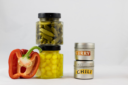 Red and yellow peppers, preserves and olive oil in the pantryの写真素材