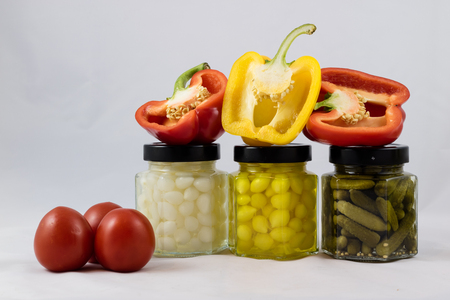 Red and yellow peppers, preserves and olive oil in the pantryの写真素材