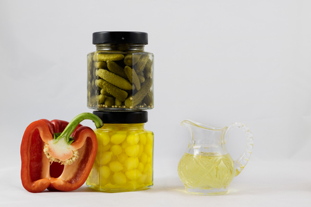 Red and yellow peppers, preserves and olive oil in the pantryの写真素材