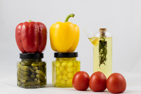 Red and yellow peppers, preserves and olive oil in the pantryの写真素材